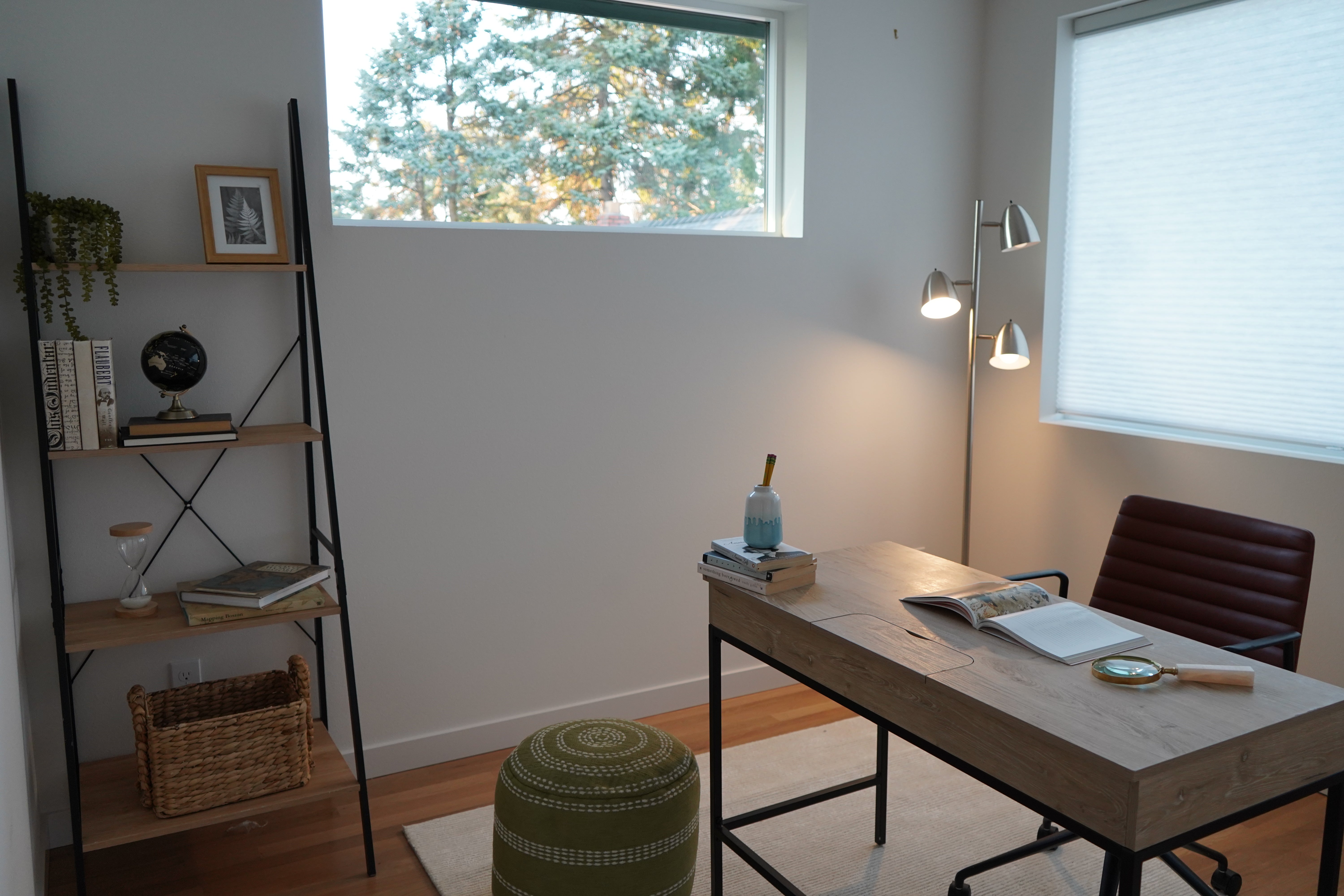 Home office with desk, chair, and bookshelf.