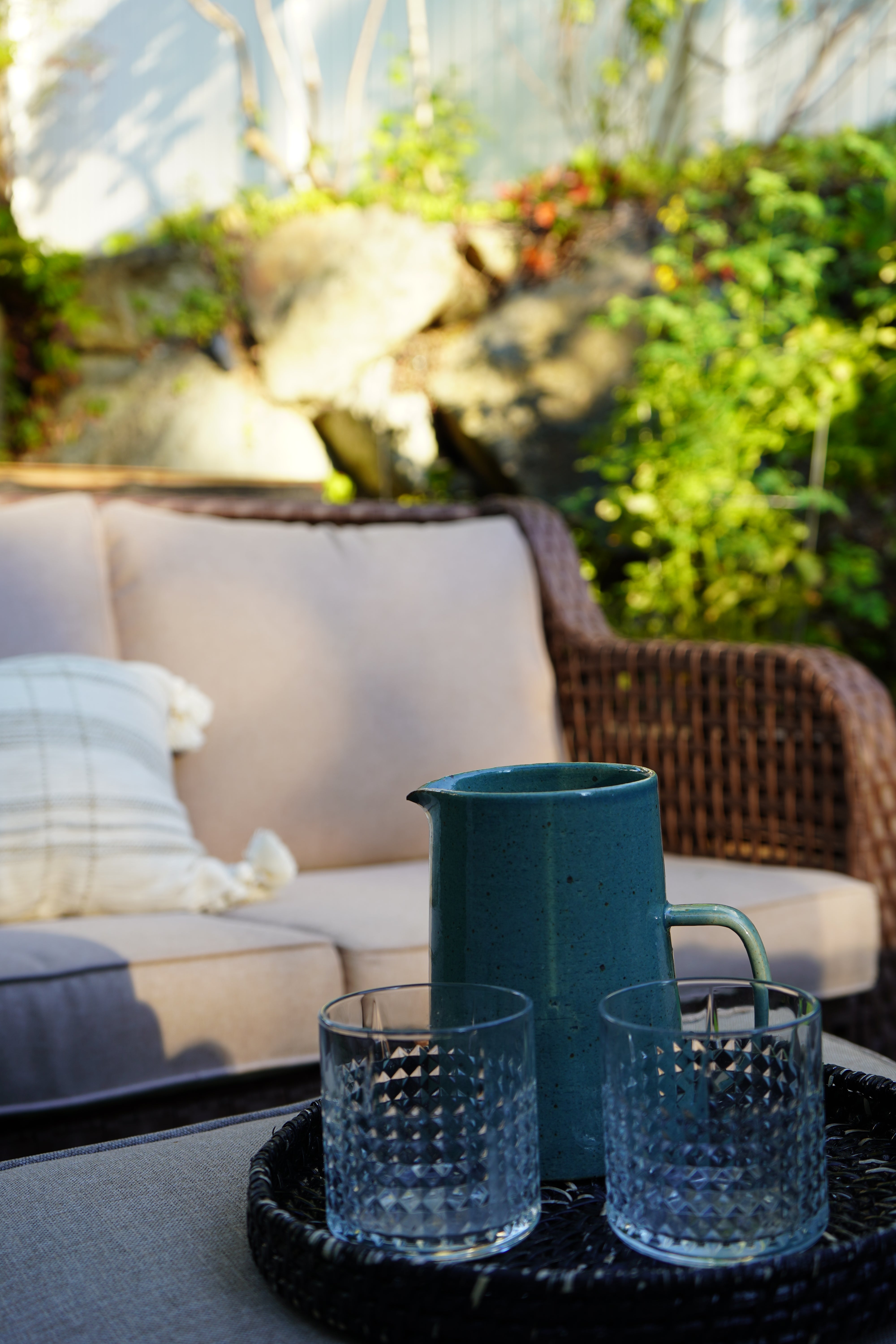 Blue textured cups on a wicker chair with a blurred natural background