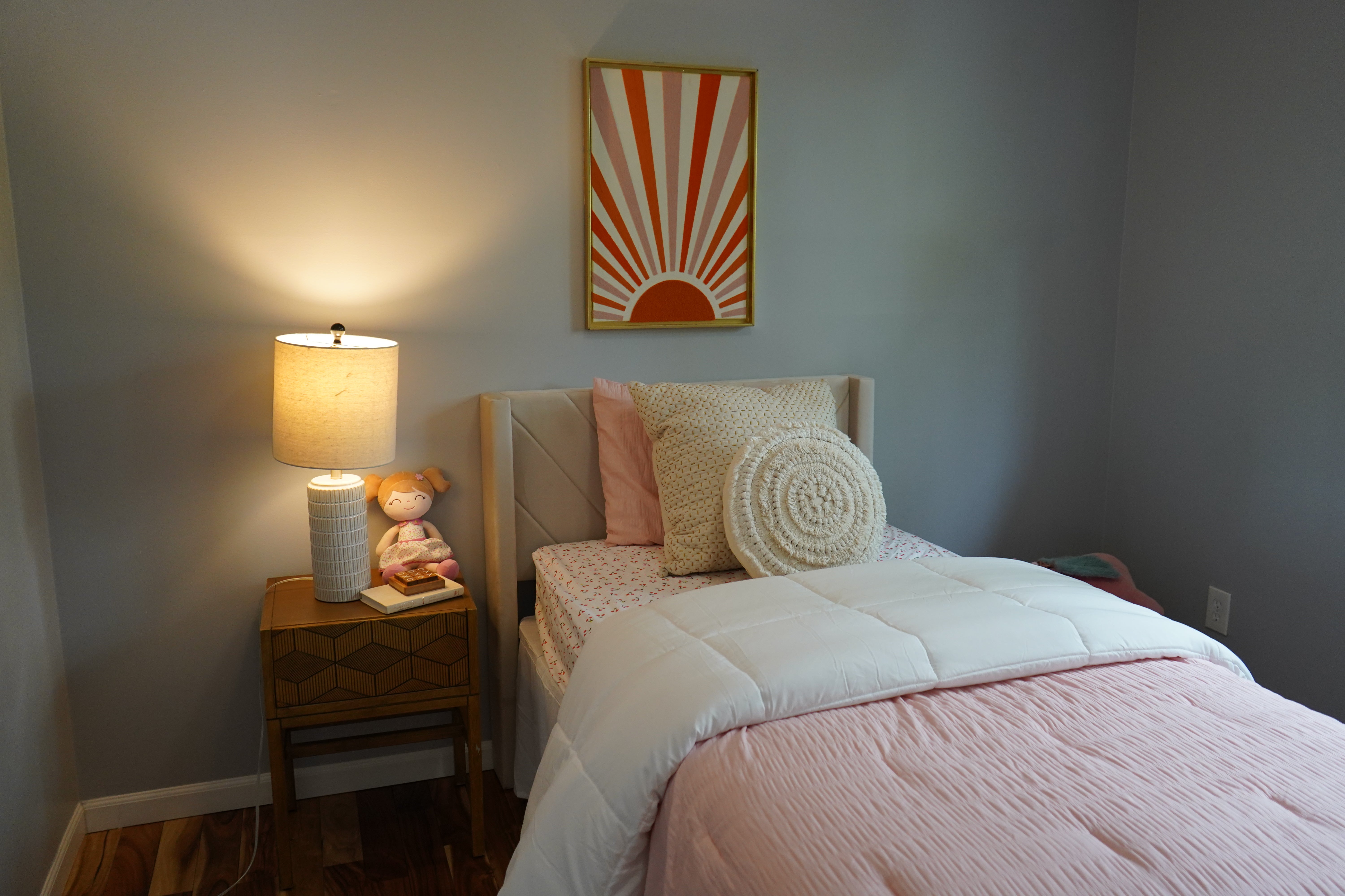 Bedroom with a bed, nightstand, and wall art