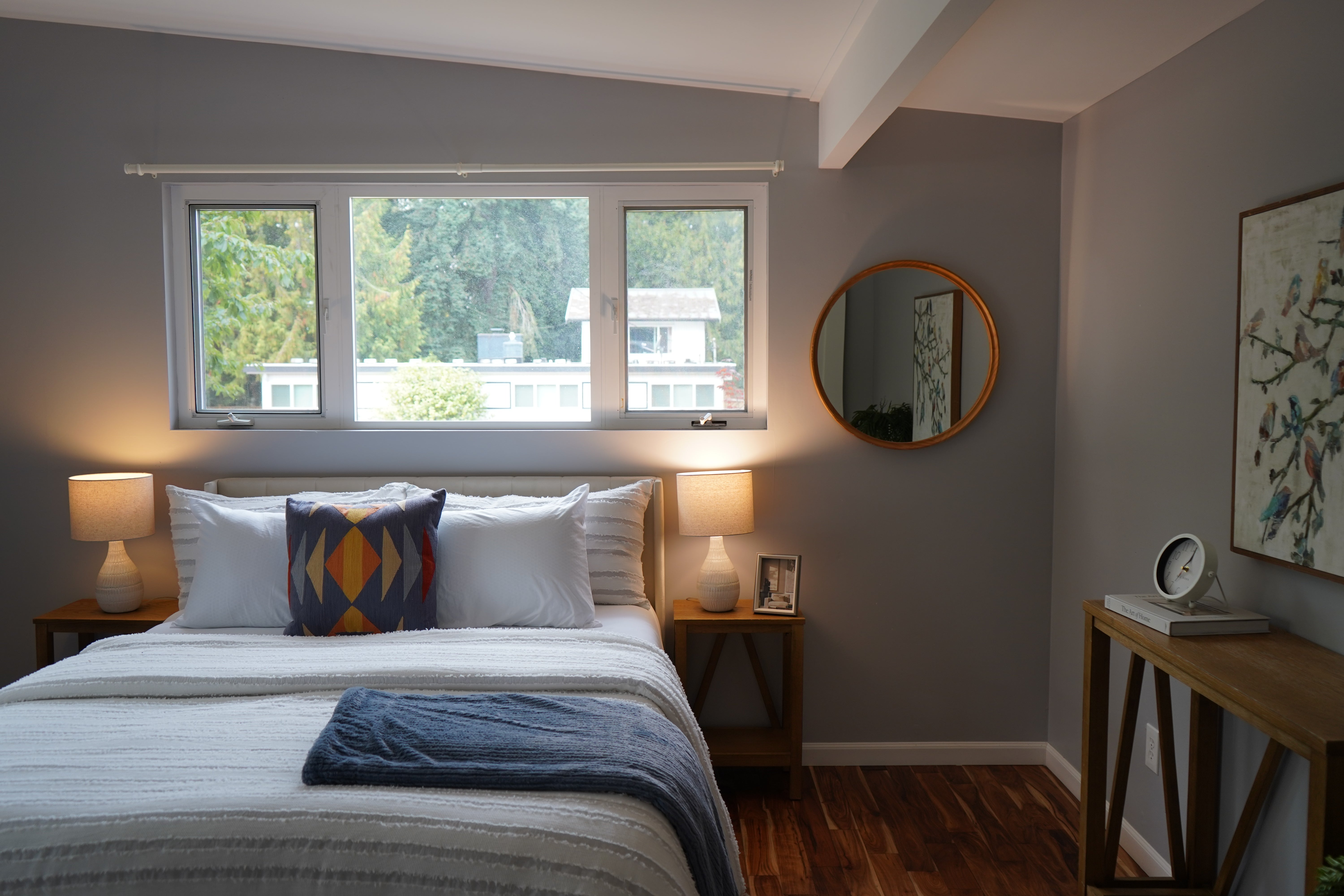 Bedroom with a bed, nightstands, and a window