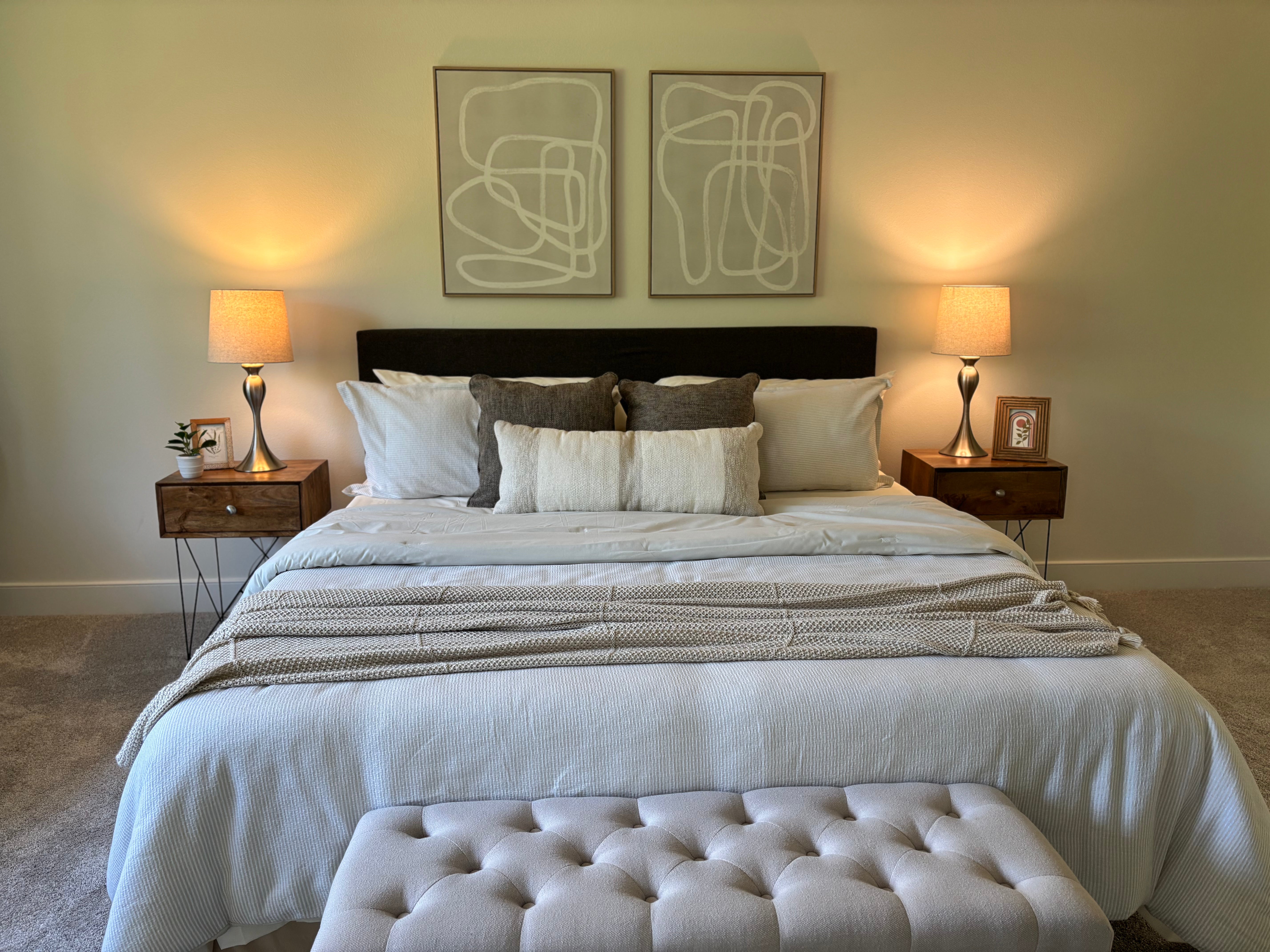 Neatly made bed with pillows and a blanket in a bedroom setting.